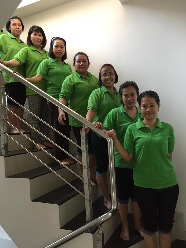 Participants in green uniforms on the staircase